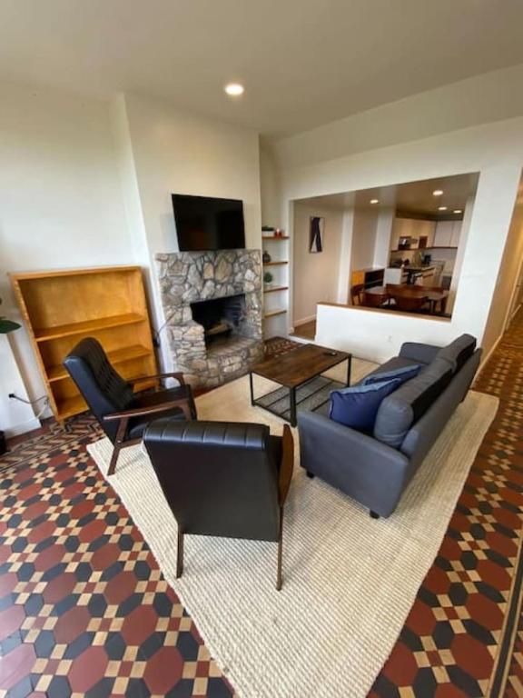a living room with a couch and a fireplace at Wonderful Fenway 3 Bed 2bath Steps from Fenway Park in Boston