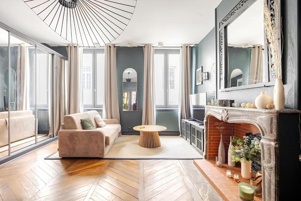 a living room with a chair and a fireplace at Nancy Vieille Ville Stanislas in Nancy