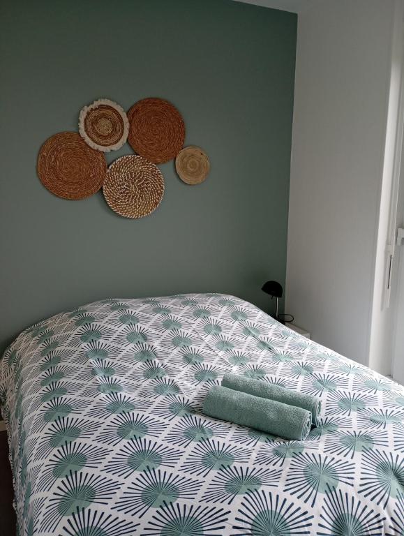 - une chambre avec un lit et une couette blanche et verte dans l'établissement Le petit nid Béthunois, à Béthune