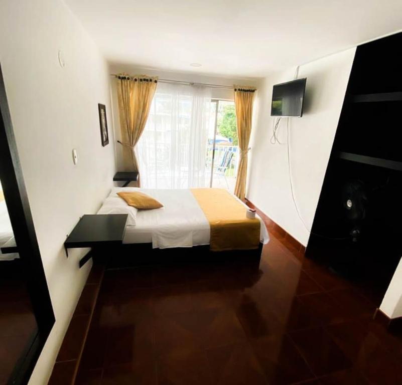 Postel nebo postele na pokoji v ubytování Hotel Zipa Villeta - Sede Tradicional