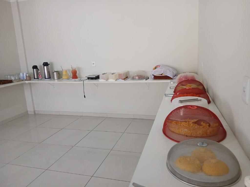 a kitchen with a table with food on it at Pousada Brilho dos Lençóis in Barreirinhas