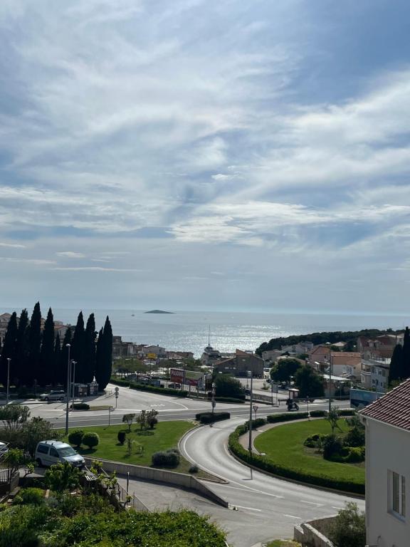 a view of a road with the ocean in the background at Casa Marelia - studio A2 in Primošten