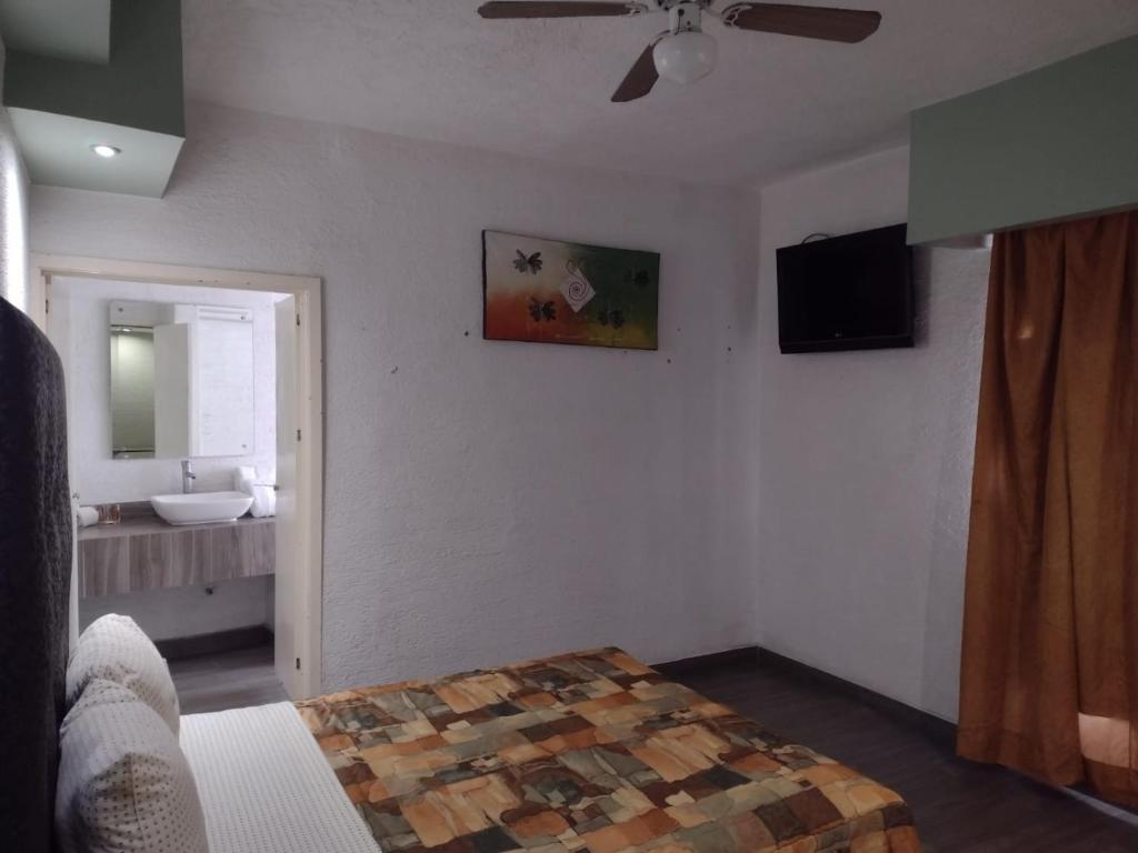 Postel nebo postele na pokoji v ubytování Hotel Metropolitan