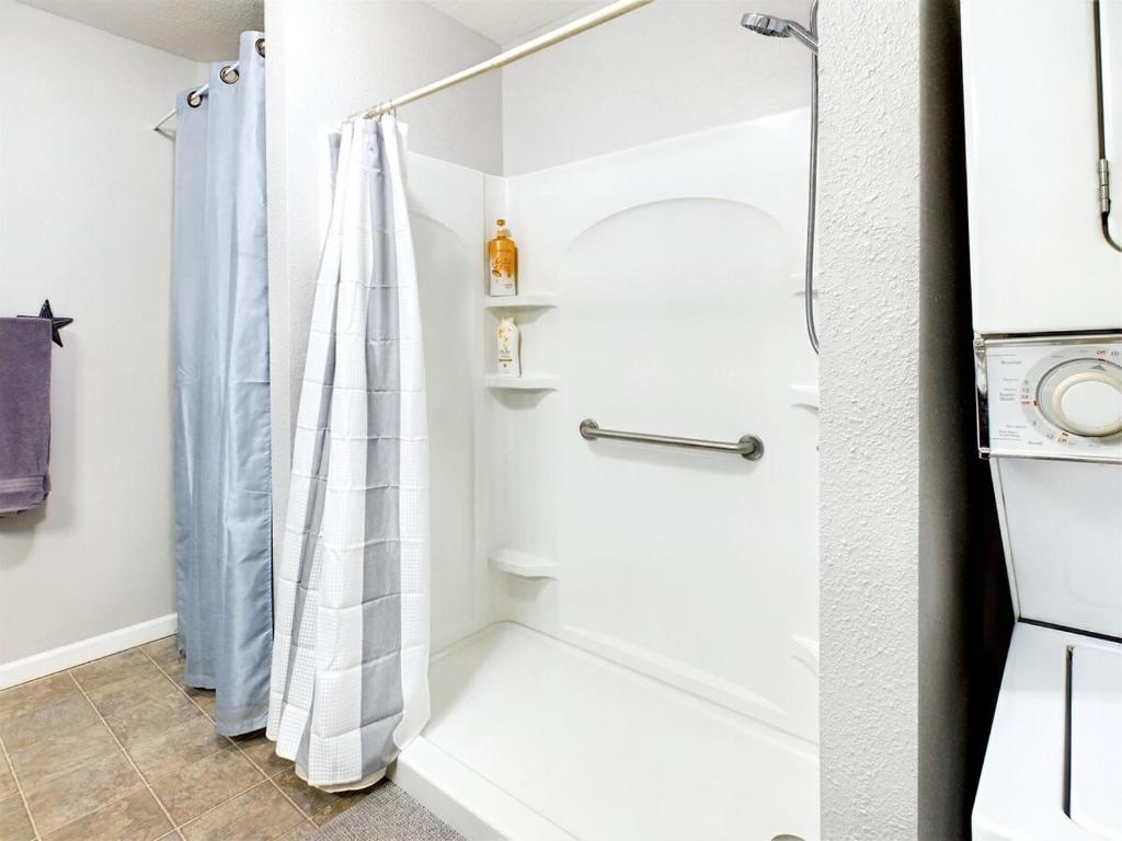 a bathroom with a shower with a shower curtain at 2 spaces More Space with 2 units at same location PNW Retreat in Philomath