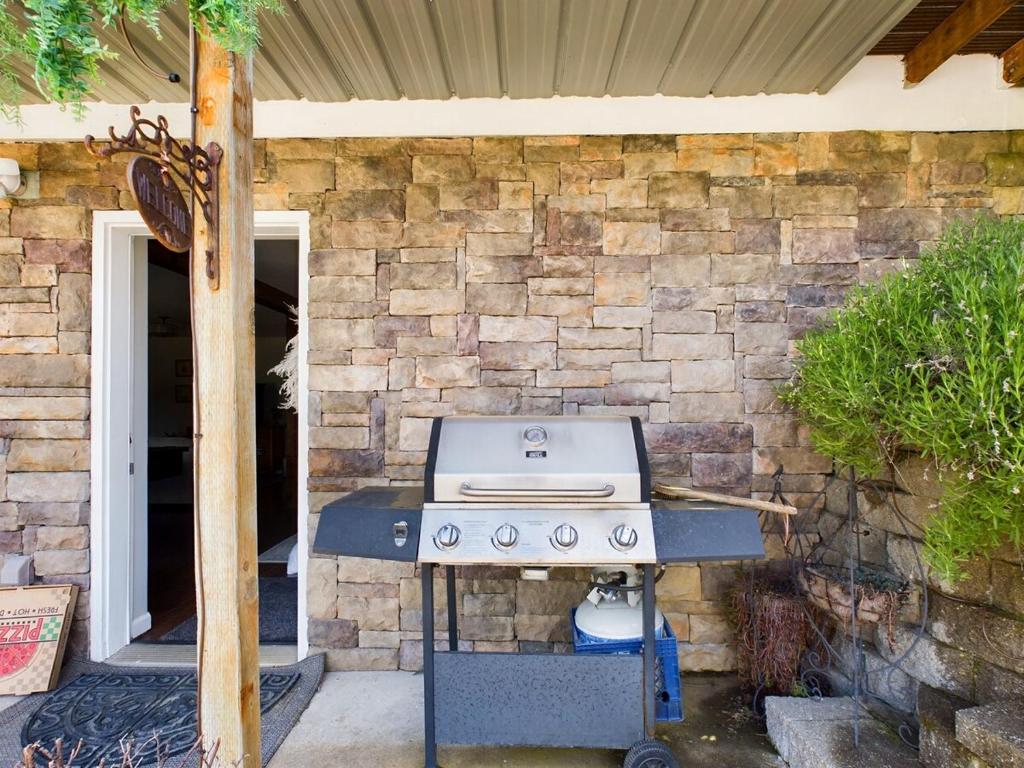 a barbecue grill in front of a brick wall at 2 spaces More Space with 2 units at same location PNW Retreat in Philomath