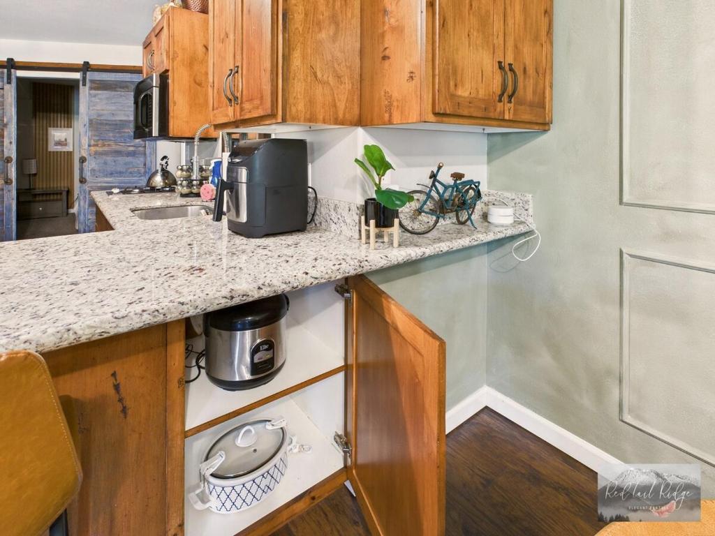 a kitchen with wooden cabinets and a counter top at 2 spaces More Space with 2 units at same location PNW Retreat in Philomath