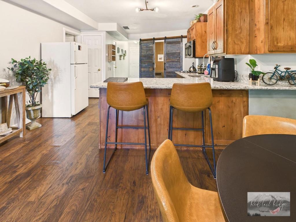 a kitchen with a counter with stools and a refrigerator at 2 spaces More Space with 2 units at same location PNW Retreat in Philomath