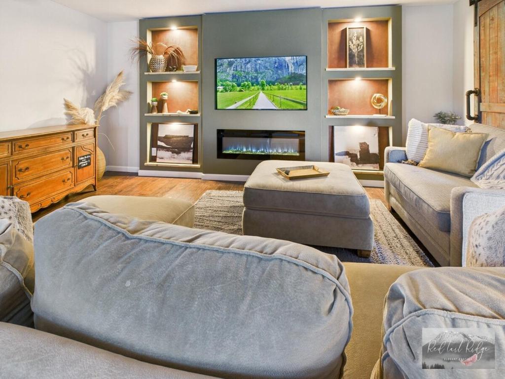 a living room with a tv on a wall at 2 spaces More Space with 2 units at same location PNW Retreat in Philomath