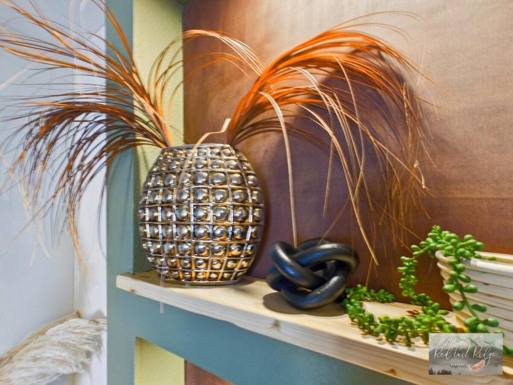 two vases sitting on a shelf next to a plant at 2 spaces More Space with 2 units at same location PNW Retreat in Philomath