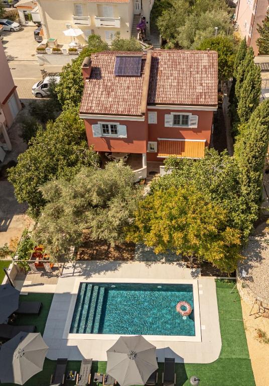 an overhead view of a house and a swimming pool at Villa Pagus with pool and private parking in Novalja