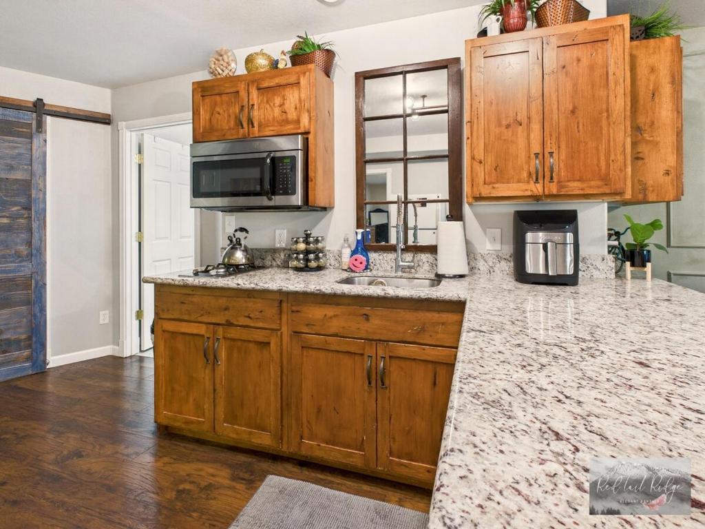a kitchen with wooden cabinets and a granite counter top at 2 spaces More Space with 2 units at same location PNW Retreat in Philomath