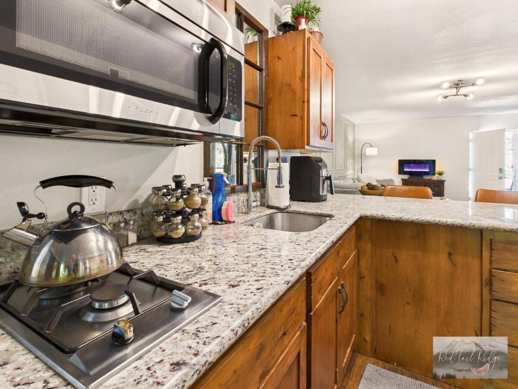a kitchen with a stove and a sink at 2 spaces More Space with 2 units at same location PNW Retreat in Philomath