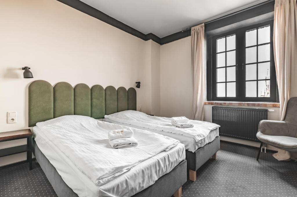 Postel nebo postele na pokoji v ubytování Aparthotel Stara Przędzalnia