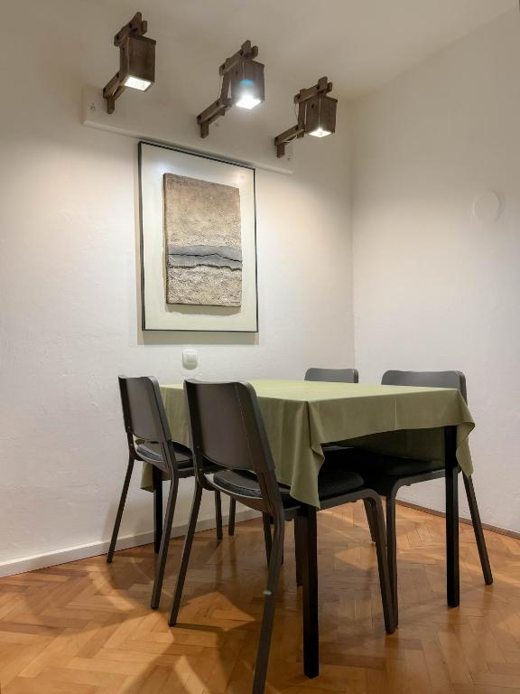 a dining room with a table and four chairs at Apartment Romeo in Crikvenica