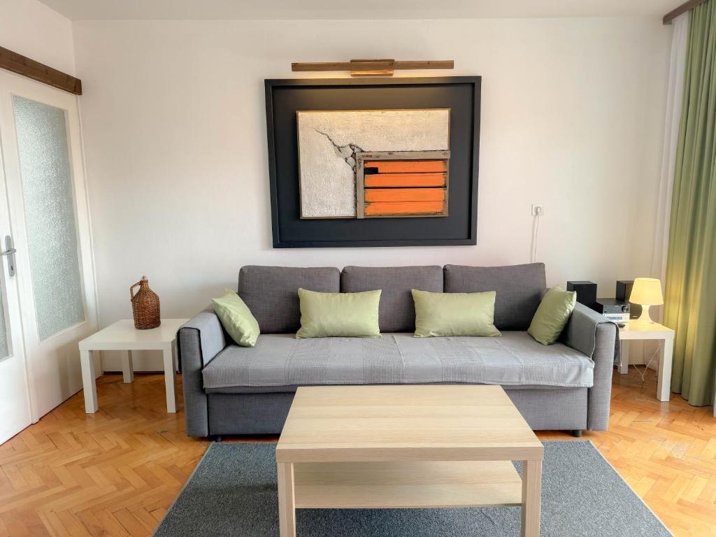 a living room with a couch and a table at Apartment Romeo in Crikvenica