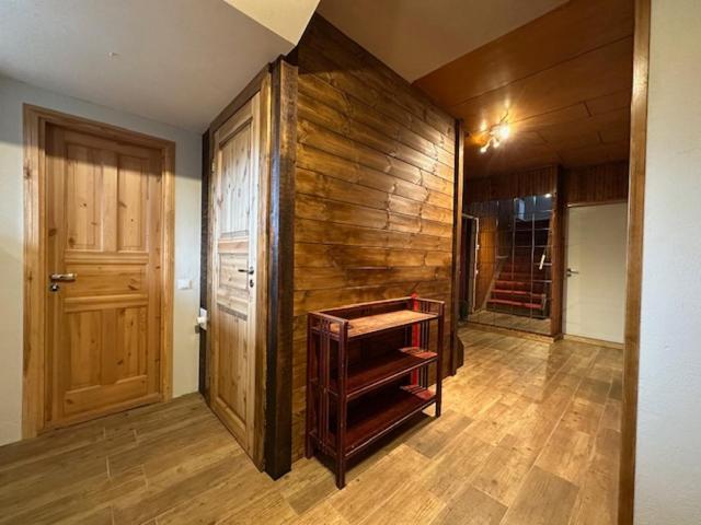 a room with wooden walls and wooden floors and a door at Kastan House in Mustvee