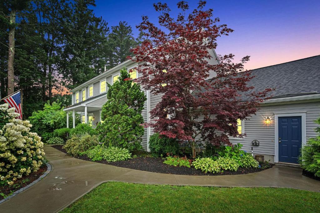 a house with a tree in the front yard at Golf & Coast Getaway 3br Tranquil Retreat in Old Orchard Beach