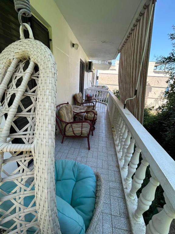 a wicker porch swing on a balcony at Pržno Residence Apartman in Budva