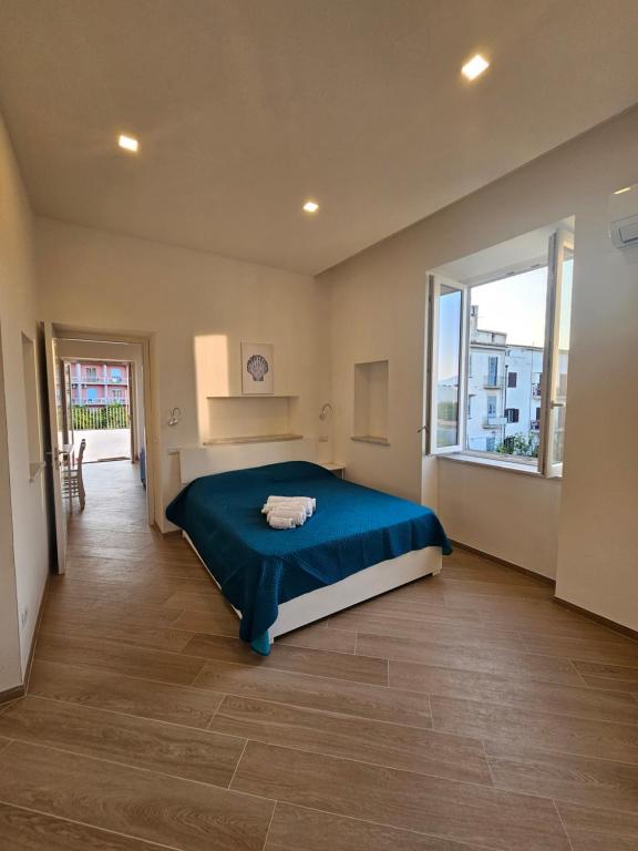a bedroom with a bed and a large window at Acquamarina in Sant'Agnello