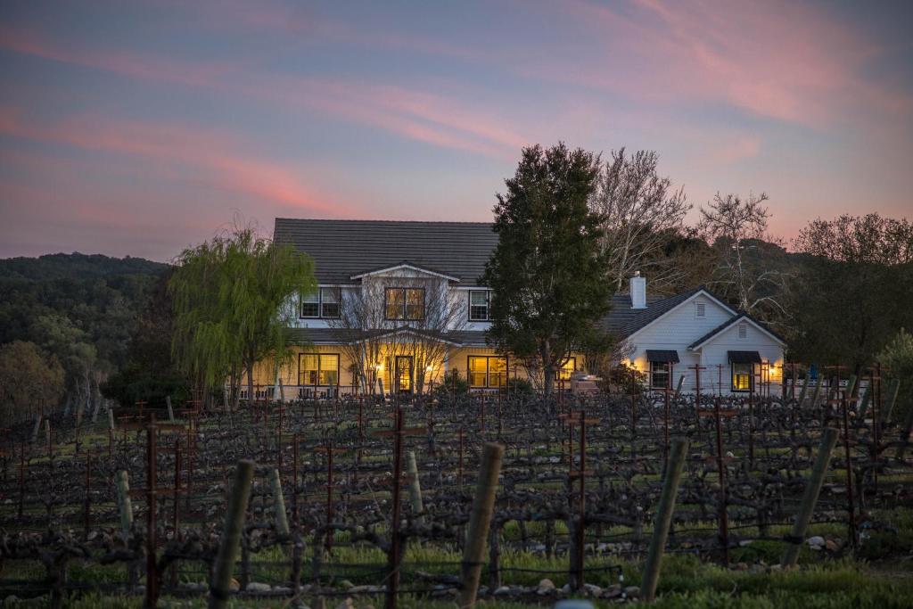 a house in a vineyard at sunset at ONX WINES - Clark House & Apartment in Templeton