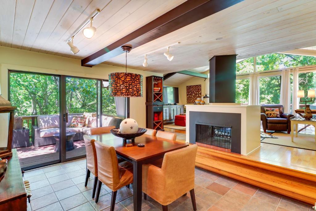 a living room with a table and a fireplace at Woodsy Mountain Home Escape Walk to Marina! in Mountain Home