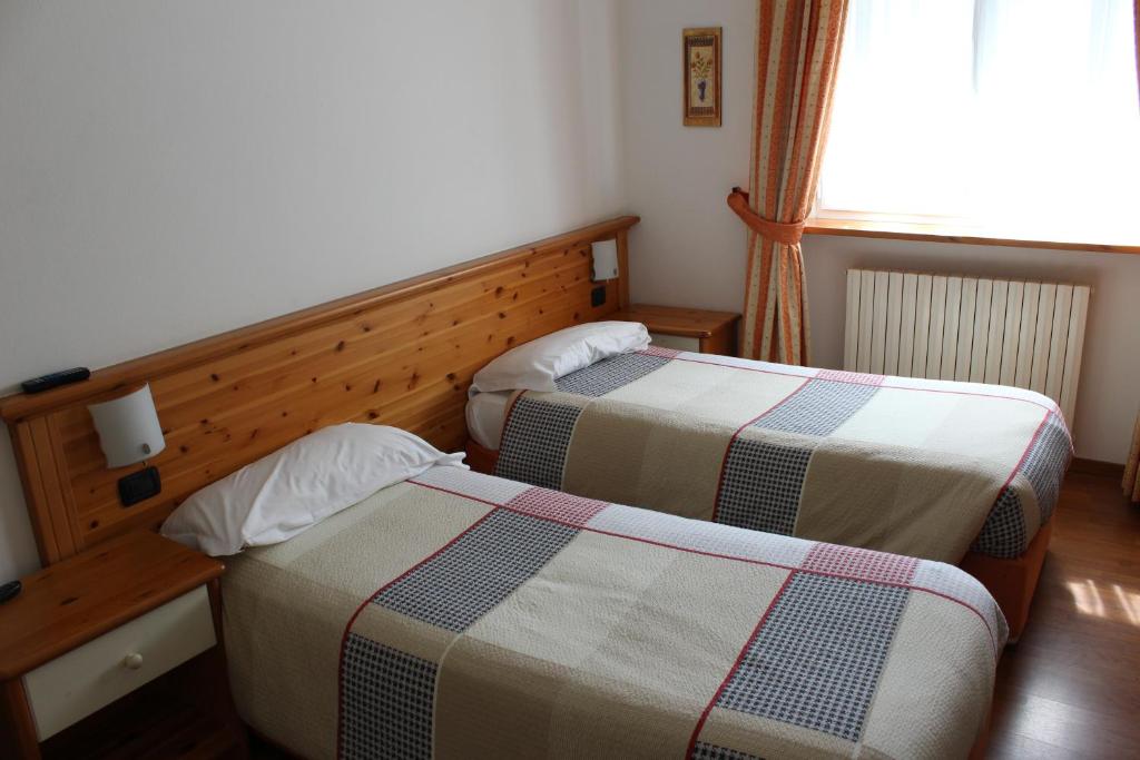 Postel nebo postele na pokoji v ubytování Hotel Culmine