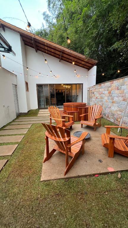 a group of benches and tables in front of a building at Casa Floresta - Caminhos de OP in Ouro Preto