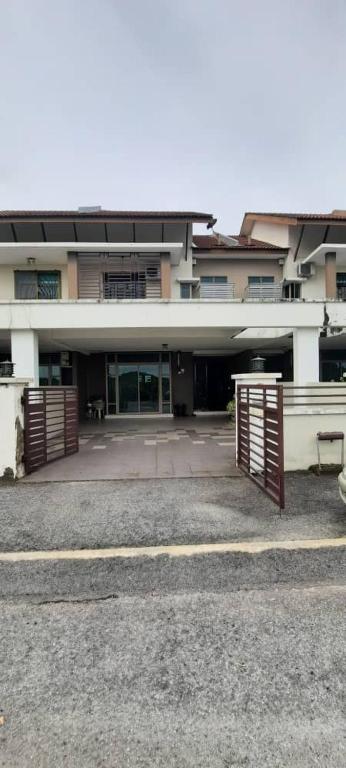a building with a gate in front of it at Homestay Ipoh Maziah in Ipoh