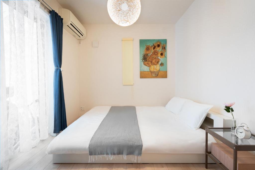 Postel nebo postele na pokoji v ubytování 島屋Minn