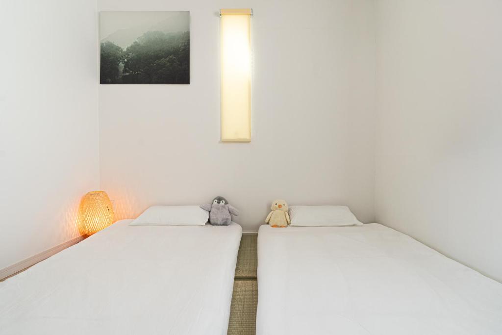Postel nebo postele na pokoji v ubytování 島屋Minn