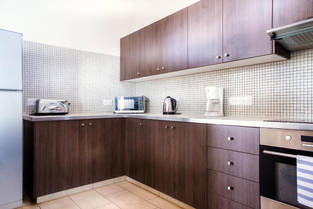 Kuchyň nebo kuchyňský kout v ubytování Napian Suites