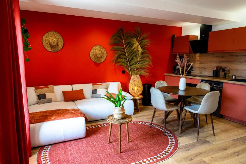 a living room with a white couch and a red wall at La Casa, Suite mexicaine d'exception à Saumur in Saumur