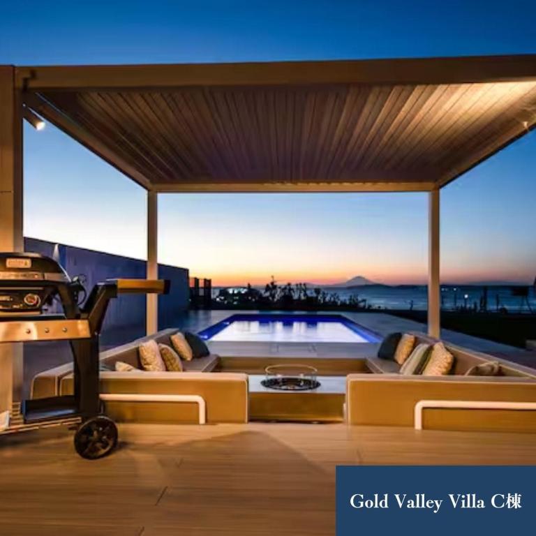 a living room with a pool on top of a building at Gold Valley Villa C in Futtsu