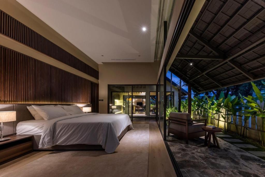 a bedroom with a bed and a balcony at Ha Garden house in Nha Trang