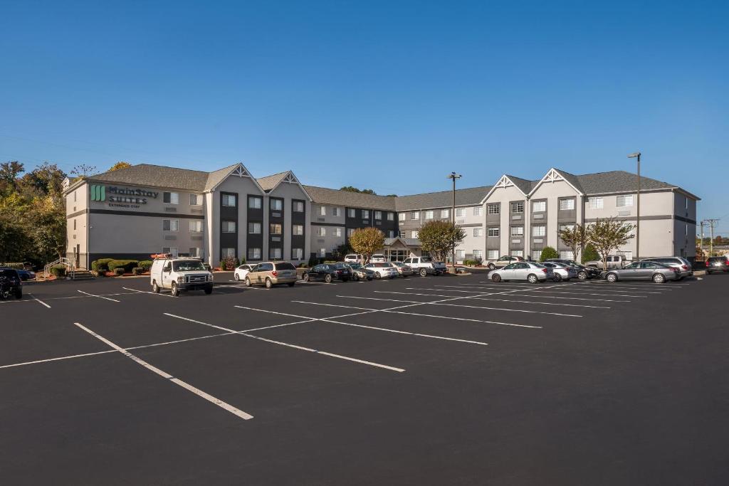 a parking lot with cars parked in front of a building at MainStay Suites Chattanooga Hamilton Place in Chattanooga