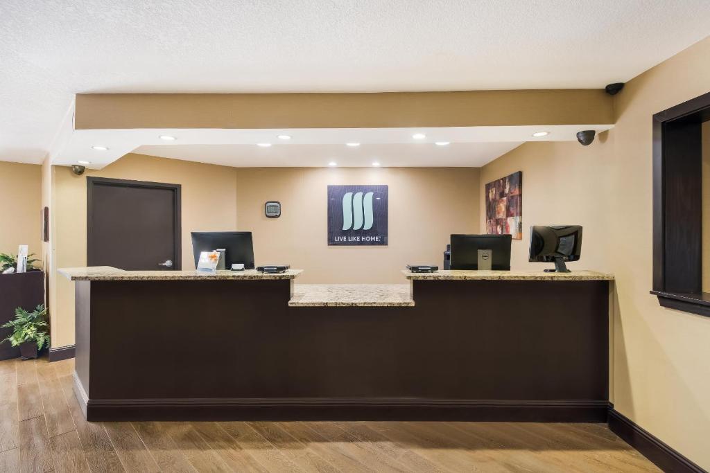 a lobby with a reception desk with two computers at MainStay Suites Chattanooga Hamilton Place in Chattanooga