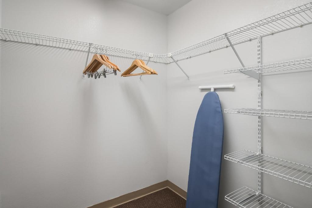 a walk in closet with shelves and a blue surfboard at MainStay Suites Chattanooga Hamilton Place in Chattanooga