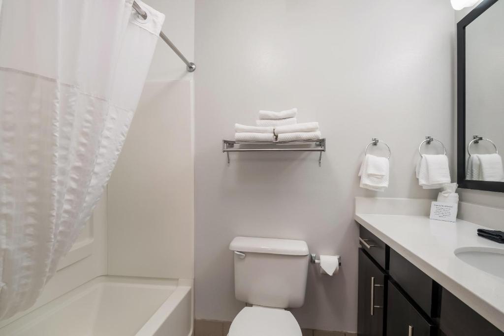 a bathroom with a shower and a toilet and a sink at MainStay Suites Chattanooga Hamilton Place in Chattanooga