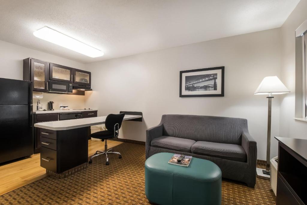 a room with a couch and a desk and a chair at MainStay Suites Chattanooga Hamilton Place in Chattanooga
