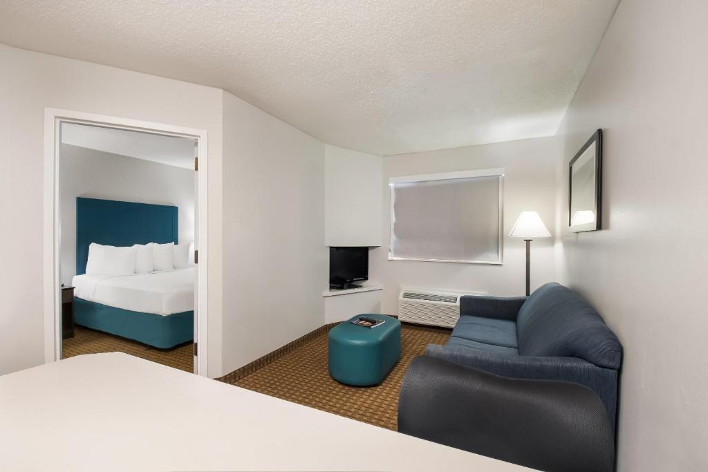 a hotel room with a bed and a chair at MainStay Suites Chattanooga Hamilton Place in Chattanooga