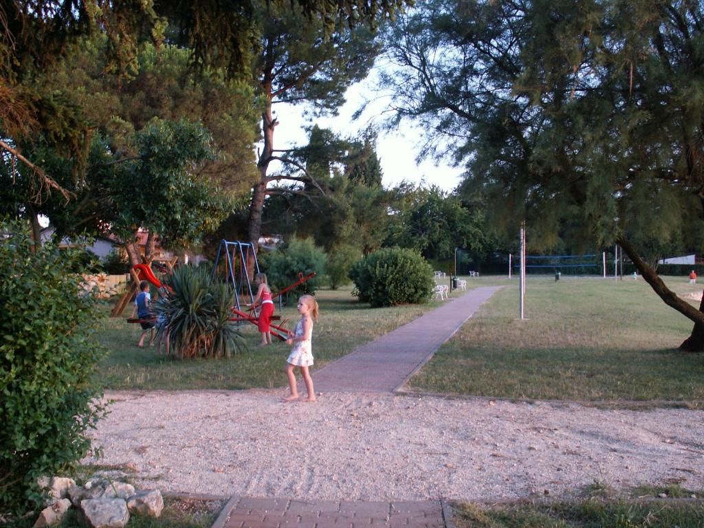 a little girl playing with a frisbee in a park at Apartment Alice in Novigrad Istria