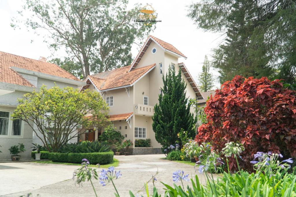 a house with a garden in front of it at Nice Dream Villas in Da Lat