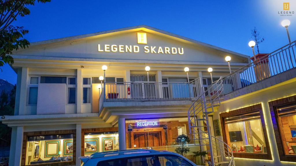 a building with a car parked in front of it at Legend Hotel Skardu in Skardu