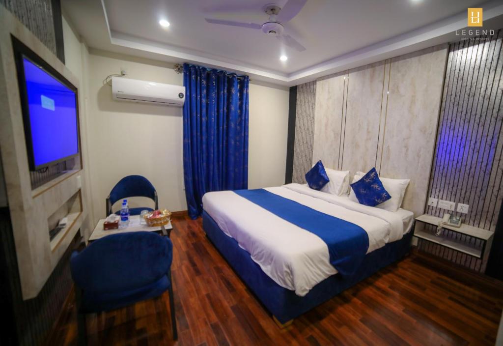 a hotel room with a bed and a tv at Legend Hotel Skardu in Skardu