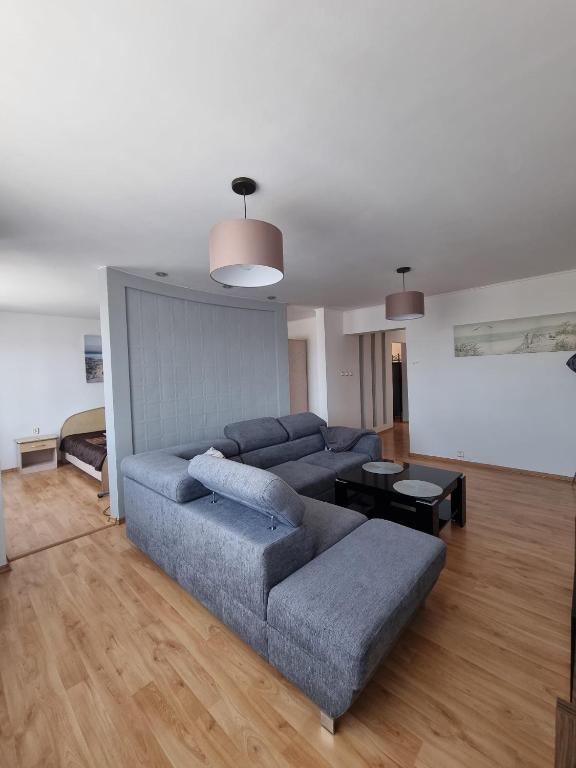 a living room with a couch and a table at Darłowska 49A in Dąbki