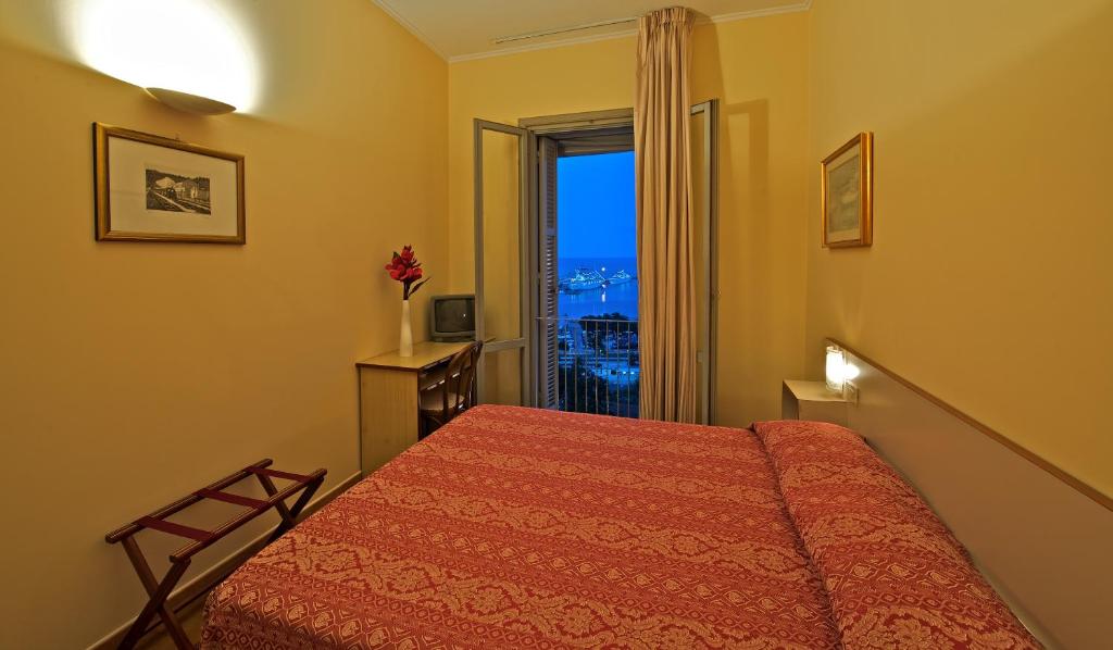 a bedroom with a bed and a window with a view at Hotel Ideale in Ortona