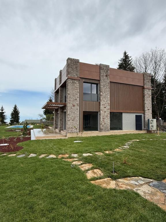 a large brick house with a lawn in front of it at villa trapeza in Trabzon