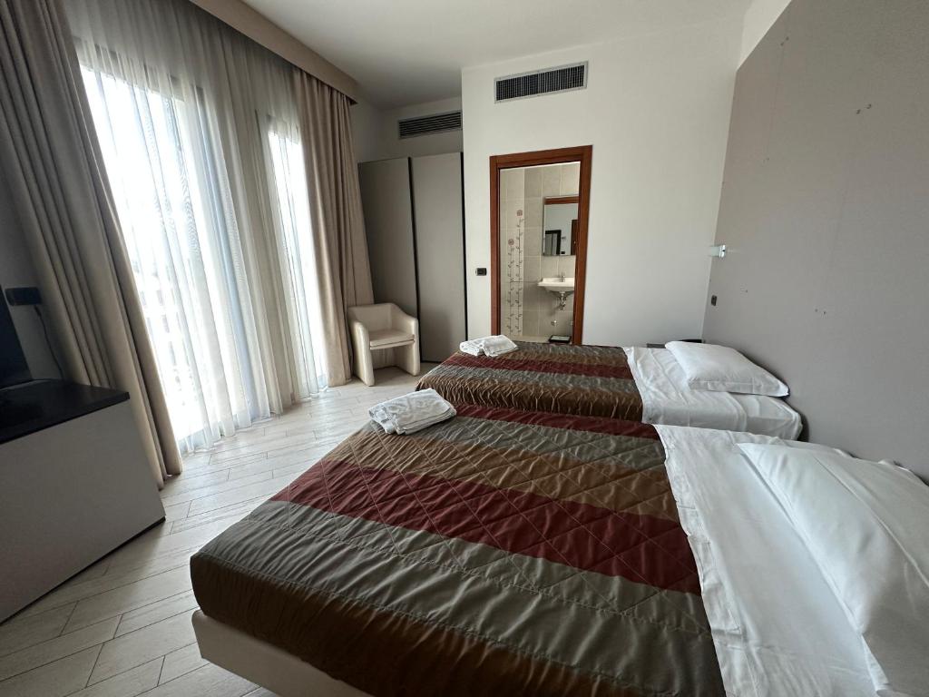 Postel nebo postele na pokoji v ubytování Hotel San Clemente