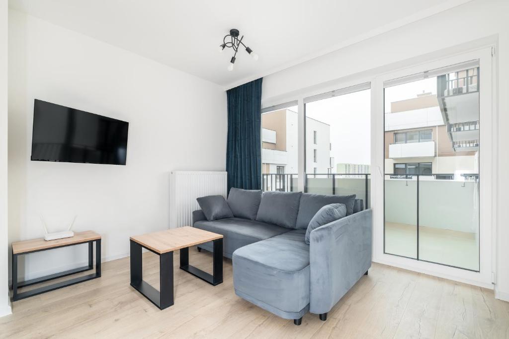 a living room with a couch and a tv at Kawalerka z Klimatem in Szczecin