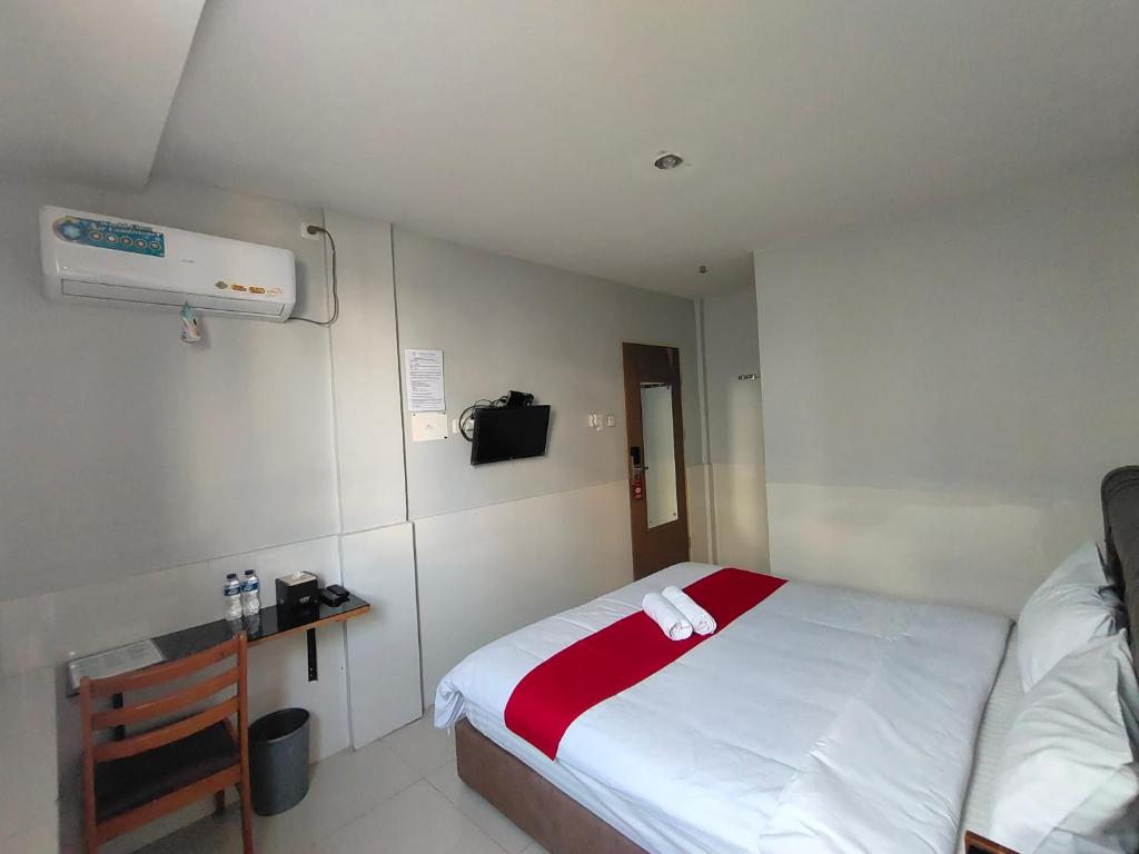 Postel nebo postele na pokoji v ubytování Permata Inn